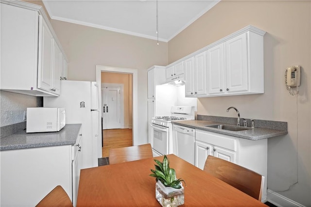 kitchen with ornamental molding, white appliances, a sink, and white cabinetry