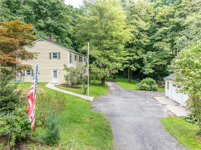 view of side of home with a lawn