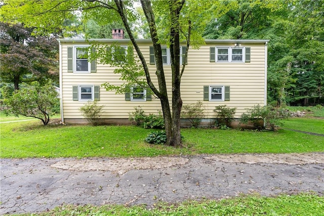 view of side of home featuring a lawn