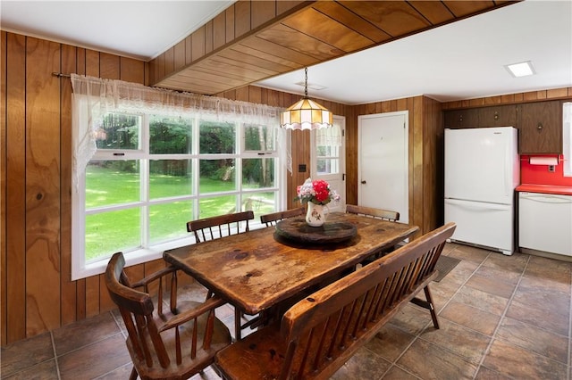 dining room featuring wood walls