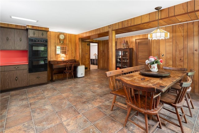 dining room with wood walls