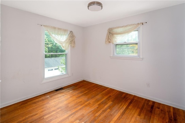 spare room with hardwood / wood-style flooring