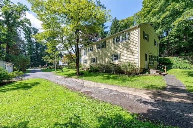 view of property exterior with a lawn