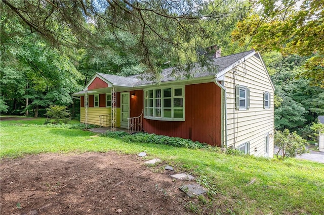 view of outbuilding with a yard