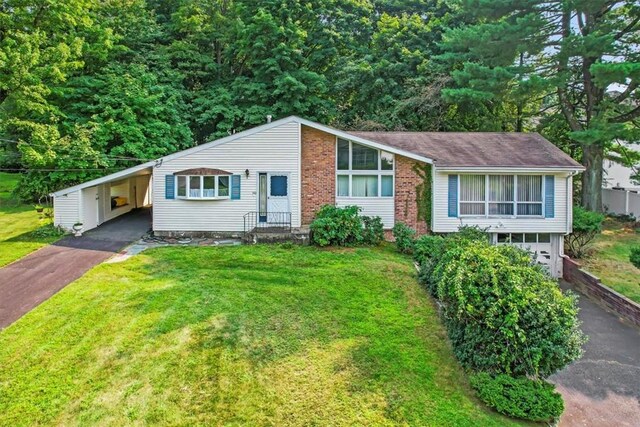 ranch-style house featuring a carport and a front lawn