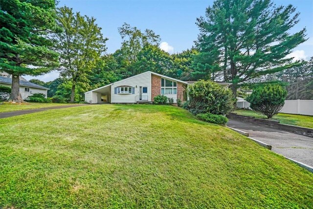 view of front of house featuring a front yard and a carport