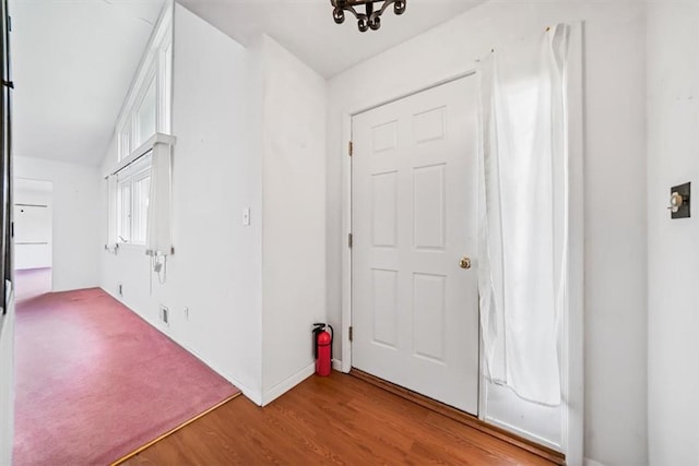 foyer with light hardwood / wood-style flooring and lofted ceiling