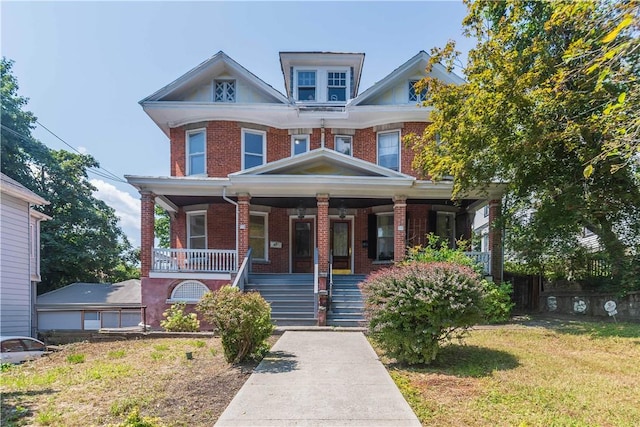 view of front facade with covered porch and a front lawn