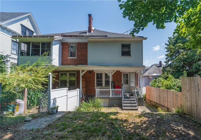 back of property with a porch