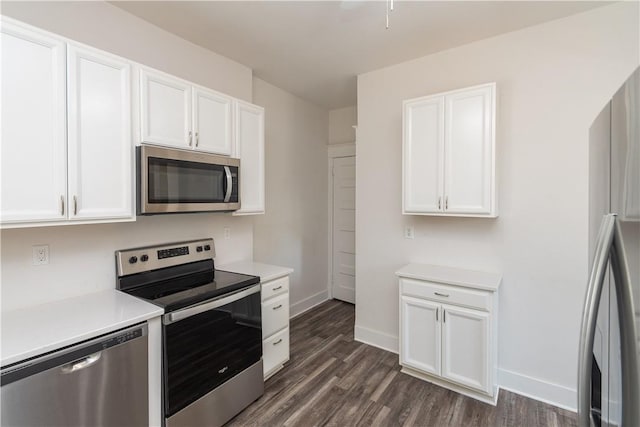 kitchen with white cabinetry, dark hardwood / wood-style floors, and appliances with stainless steel finishes