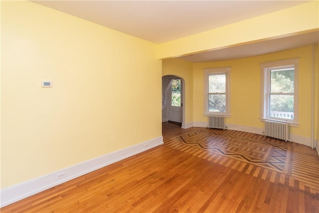 interior space featuring radiator heating unit and hardwood / wood-style flooring