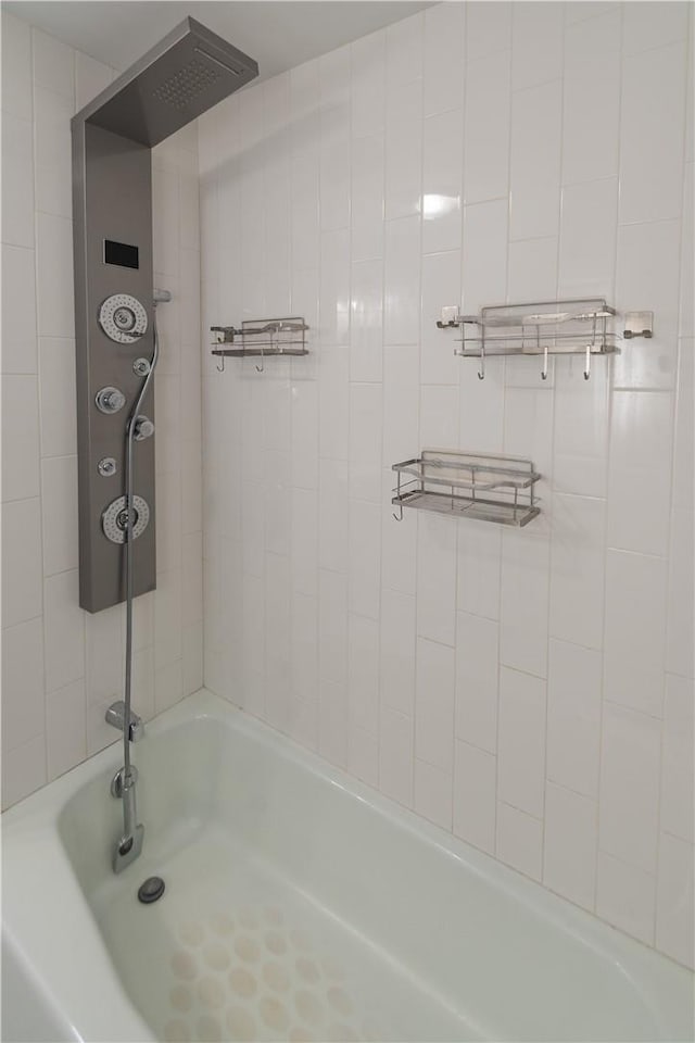 bathroom featuring tiled shower / bath