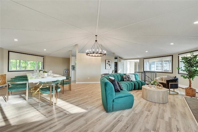 living room featuring light hardwood / wood-style floors and an inviting chandelier