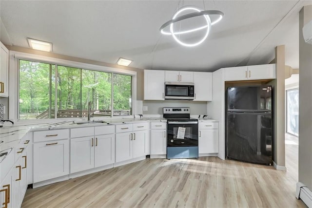 kitchen featuring stainless steel appliances, white cabinetry, a wealth of natural light, and sink