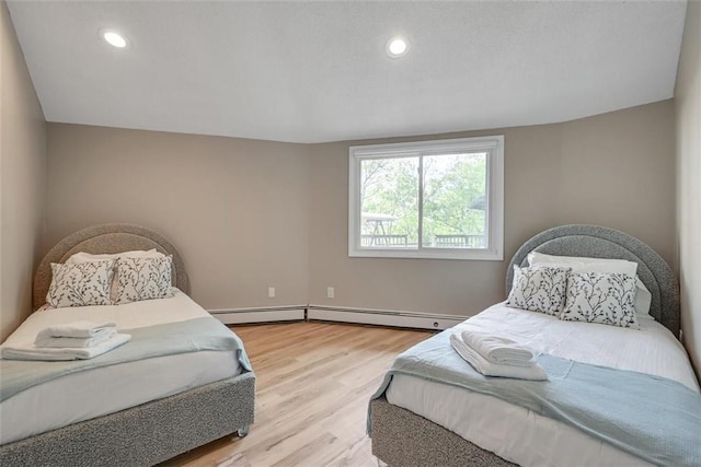 bedroom with lofted ceiling and light wood-type flooring