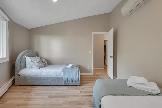 bedroom featuring a baseboard radiator, light hardwood / wood-style flooring, a wall unit AC, and lofted ceiling