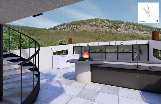 view of patio with sink and an outdoor fire pit