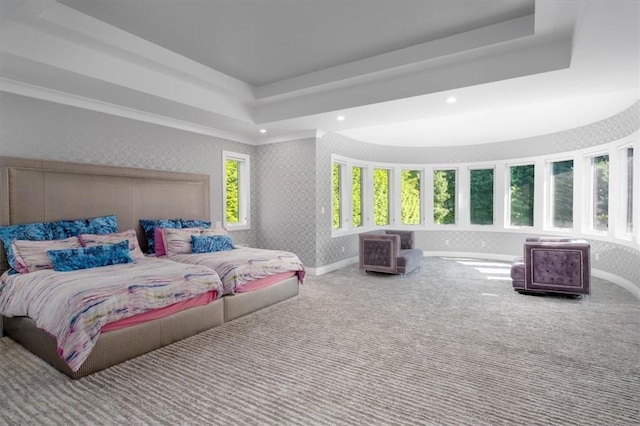 carpeted bedroom with a tray ceiling