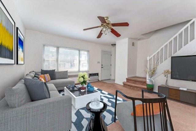 living room with carpet flooring, ceiling fan, and radiator