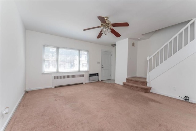 unfurnished living room featuring radiator, ceiling fan, and light carpet