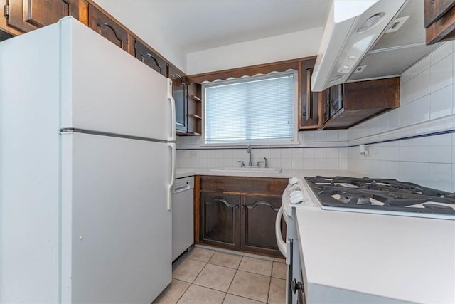 kitchen with white appliances, ventilation hood, sink, decorative backsplash, and light tile patterned flooring