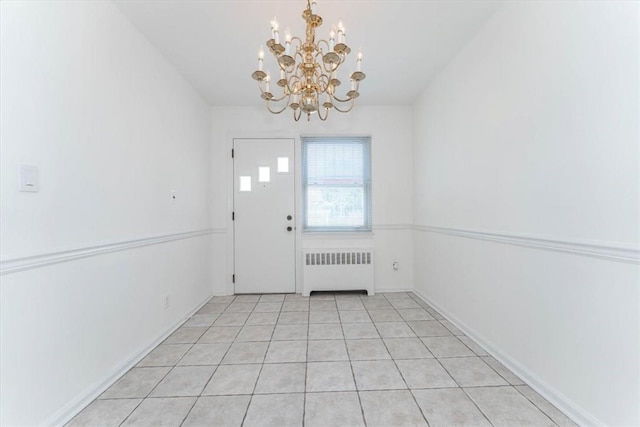 doorway featuring a notable chandelier, light tile patterned floors, and radiator