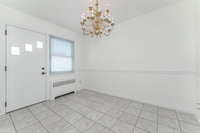 foyer featuring radiator heating unit, light tile patterned floors, and a chandelier