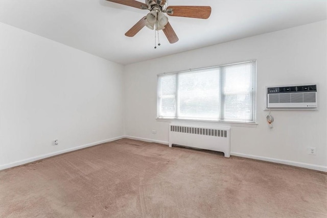 carpeted empty room featuring radiator heating unit, a wall mounted AC, and ceiling fan