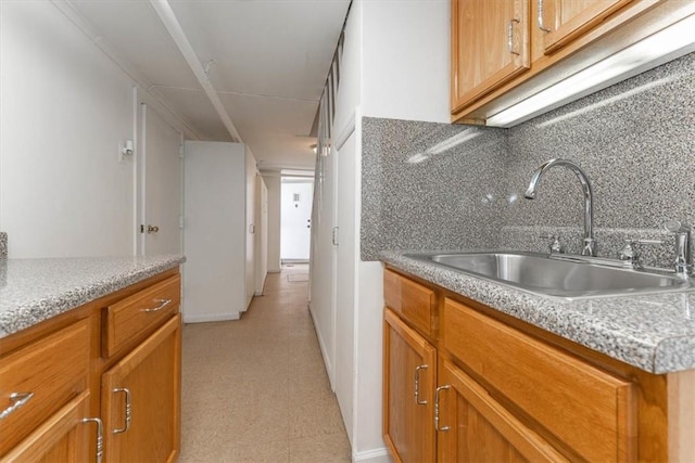 kitchen featuring backsplash and sink