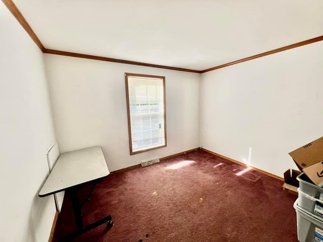 carpeted spare room with crown molding