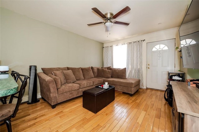 living room with ceiling fan and light hardwood / wood-style flooring