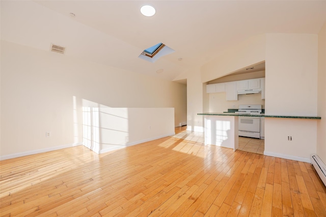 unfurnished living room with light hardwood / wood-style flooring, a skylight, and a baseboard heating unit