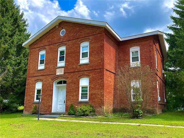 16 Orchard Dr, Rhinecliff, NY 12574 - view of front facade with brick siding and a front lawn