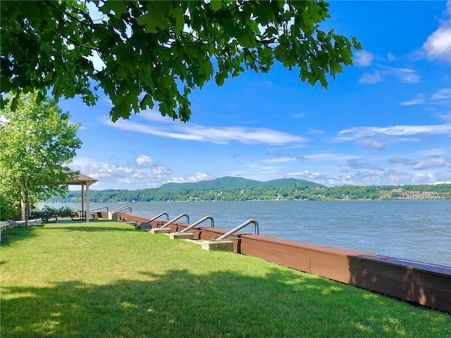 water view with a mountain view and a boat dock