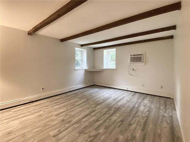 empty room with beam ceiling, hardwood / wood-style floors, and a wall mounted air conditioner