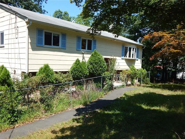 view of side of home featuring a yard