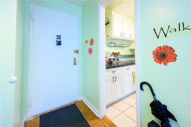 doorway to outside featuring light tile patterned floors