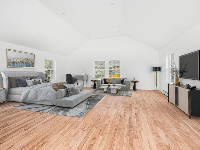 bedroom featuring light hardwood / wood-style floors, a baseboard radiator, multiple windows, and lofted ceiling