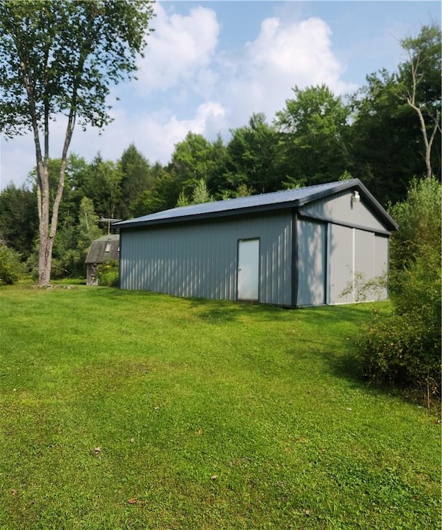 view of outbuilding featuring a yard