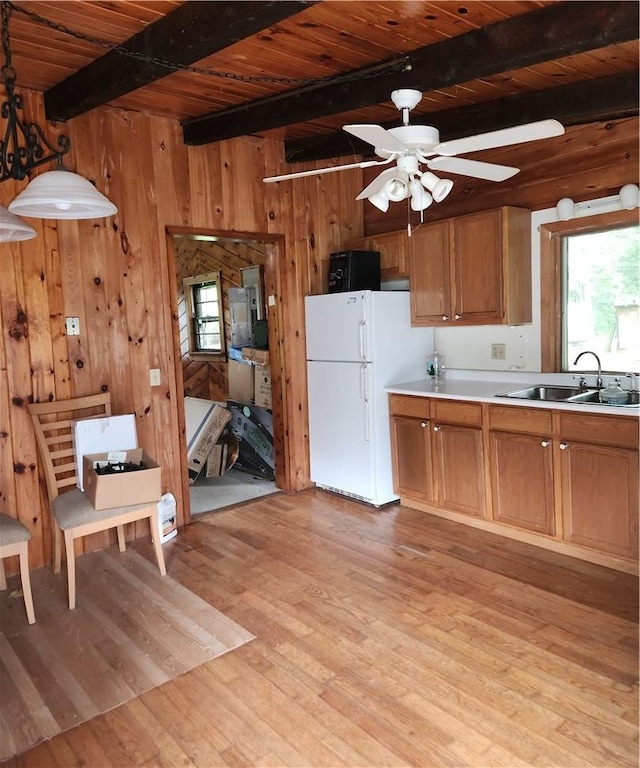 kitchen with wood ceiling, sink, white refrigerator, decorative light fixtures, and light hardwood / wood-style flooring