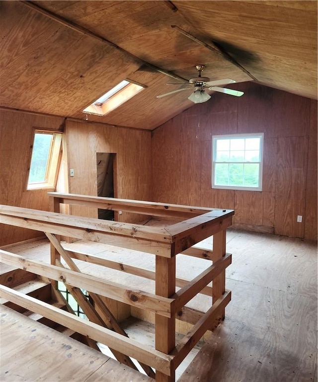 bonus room featuring wood ceiling, ceiling fan, and vaulted ceiling with skylight