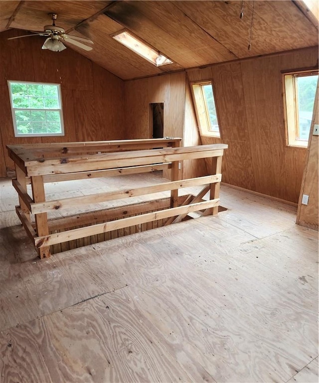 interior space featuring ceiling fan, a healthy amount of sunlight, lofted ceiling, and wooden ceiling