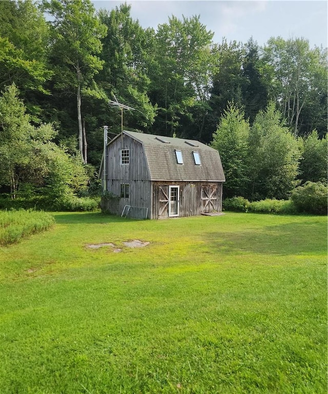 view of outbuilding featuring a yard