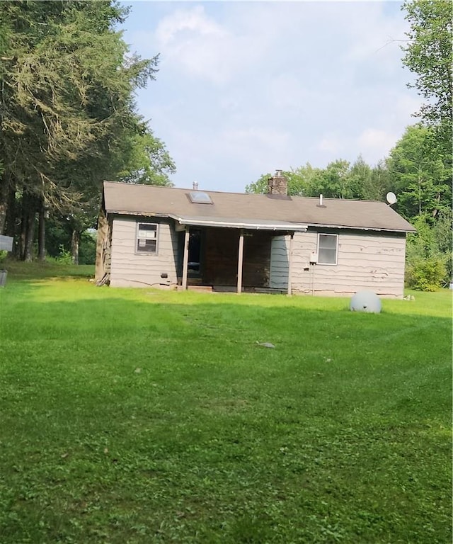 back of house with a yard