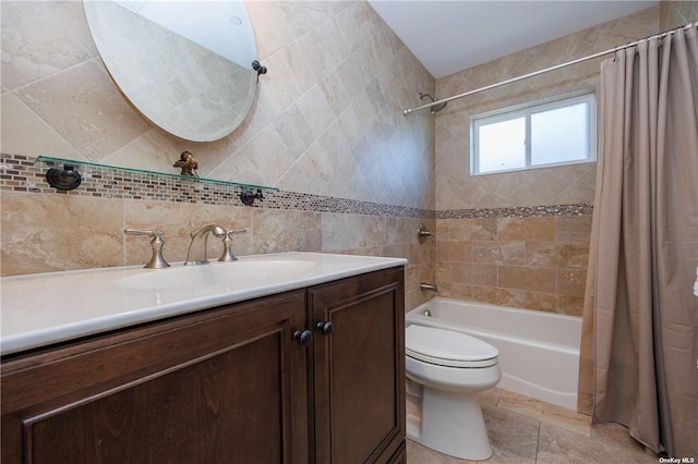 full bathroom with shower / bath combination with curtain, vanity, tile walls, tile patterned flooring, and toilet