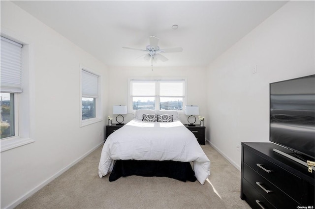 carpeted bedroom with multiple windows and ceiling fan