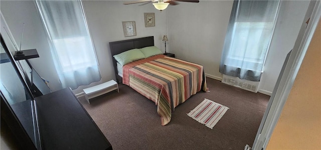 bedroom with ceiling fan and dark colored carpet