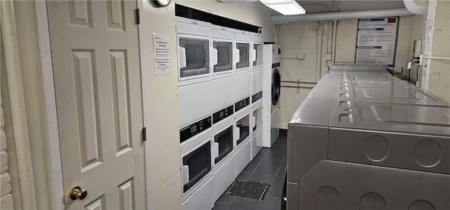 washroom featuring stacked washer and dryer and washer and clothes dryer