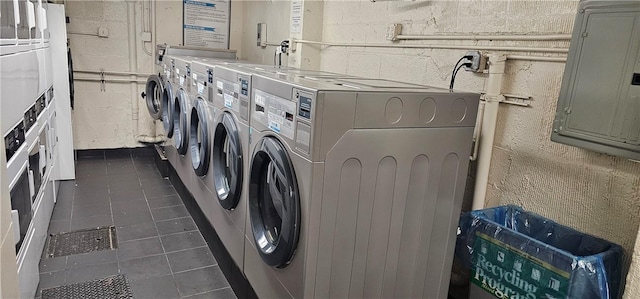 washroom with electric panel and separate washer and dryer