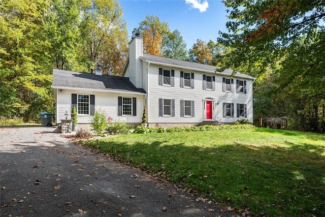 colonial-style house with a front yard